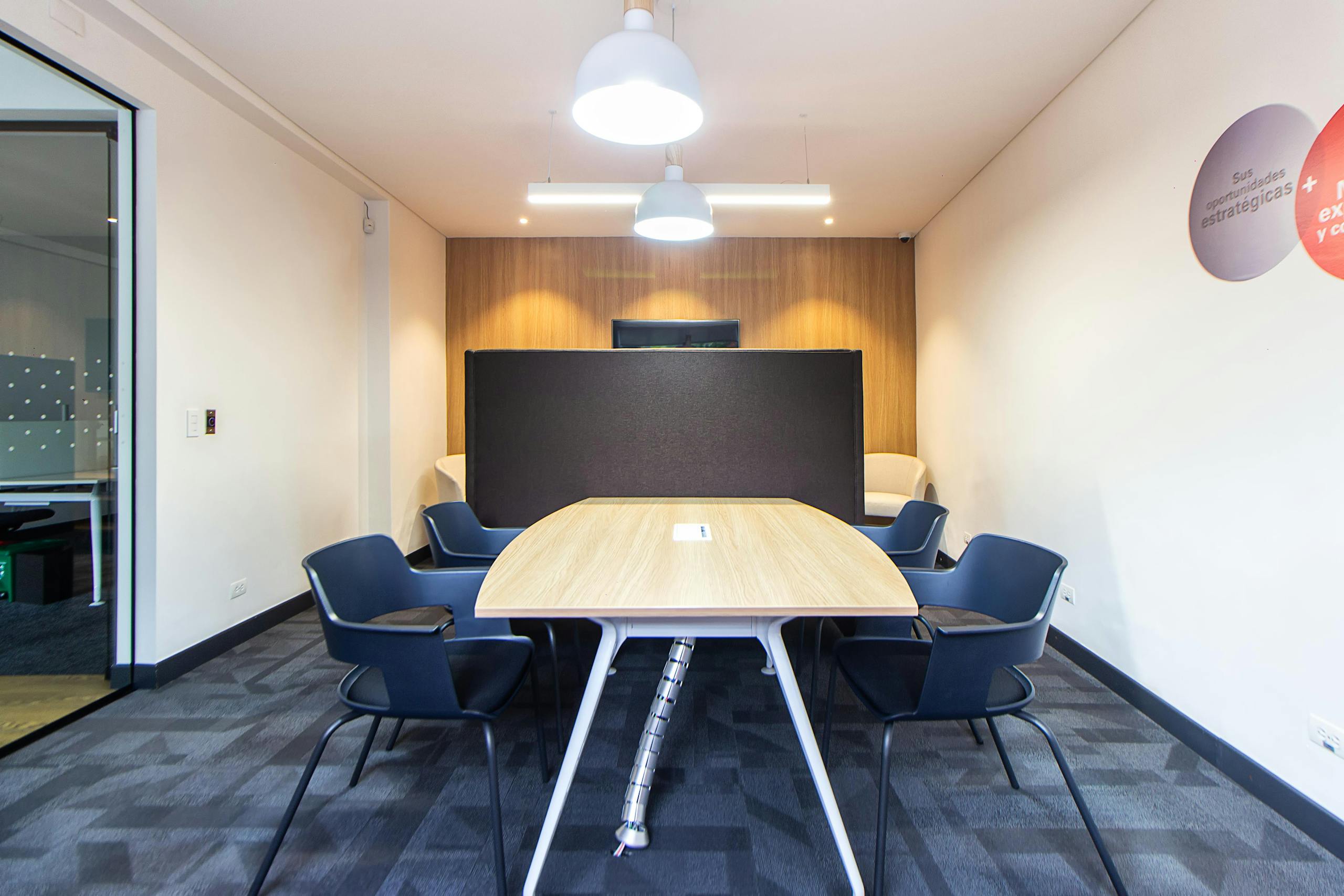 Contemporary conference room with stylish furniture and lighting, ideal for meetings.
